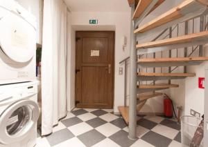 a small house with a staircase and a washing machine at Rainbow Rooms in Ljubljana