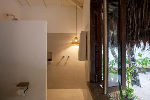a bathroom with a light hanging from the wall at Casa Vida : Charme, Comforto e Localização in Trancoso +22 photos