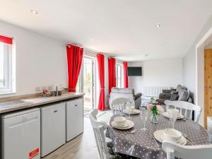 a kitchen and living room with a table and chairs at Hill Crest Lodge 2 in Hemswell