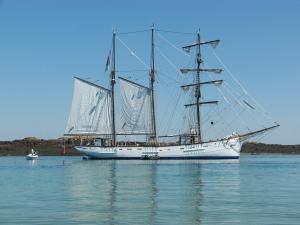 a large white sail boat sitting in the water at Résidence Saint-Nicolas Granville in Granville