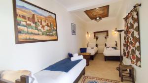 Postel nebo postele na pokoji v ubytování RIAD DAR En-Nawat