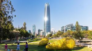 a group of people in a park with a tall building at Holiday Inn Express Santiago Las Condes, an IHG Hotel in Santiago