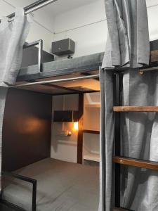a small room with a bunk bed with a window at Wanderlust Hostel & Home Stay in Varanasi