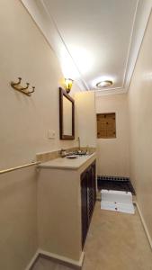 a bathroom with a sink and a mirror at RIAD DAR En-Nawat in Marrakech