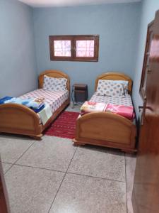 two beds sitting next to each other in a room at PalmTree A/2 in El Jadida