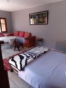 a bedroom with a large bed and a couch at PalmTree A/2 in El Jadida
