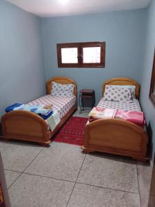 two beds sitting next to each other in a room at PalmTree A/2 in El Jadida