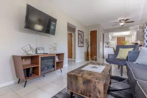 a living room with a couch and a tv on the wall at Fifties Flat MidCentury flat in heart of Brandon in Brandon