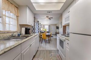a kitchen with white cabinets and a dining room at Fifties Flat MidCentury flat in heart of Brandon in Brandon