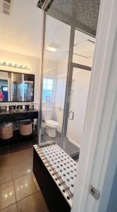 a bathroom with a shower and a sink and a toilet at Hollywood house with parking - walk to attractions in Los Angeles