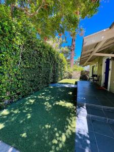 a house with a walkway next to a yard at Hollywood house with parking - walk to attractions in Los Angeles