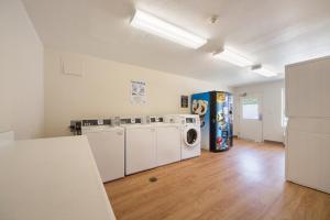 a laundry room with a washer and dryer at HomeTowne Studios by Red Roof Dallas - Irving in Irving