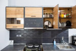 a kitchen with a sink and a counter top at MATILDA Central Apartment in Aegina Town