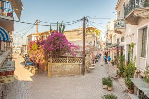 a city street with plants and flowers on it at MATILDA Central Apartment in Aegina Town