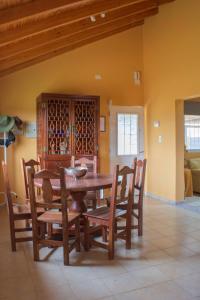 a dining room with a wooden table and chairs at Casa Bodega Antucura in Vista Flores