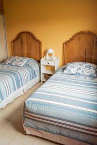two beds sitting next to each other in a bedroom at Casa Bodega Antucura in Vista Flores