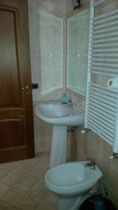 a bathroom with a sink and a toilet at B&B Manzoni Resort in Brindisi