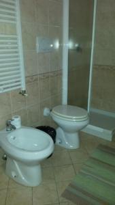 a bathroom with a toilet and a sink and a shower at B&B Manzoni Resort in Brindisi