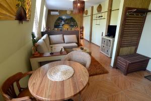 a living room with a table and a couch at Dragomir Apartments in Cherkasy