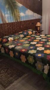a bedroom with a bed with a colorful comforter at Casa con giardino vicino al mare in Massa