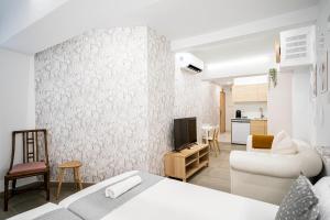 a bedroom with a bed and a living room at dobohomes - Horcajuelo in Madrid