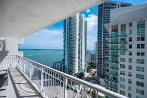 a balcony with a view of the ocean and buildings at Luxurious 1 Bed Apartment in Brickell • Ocean View in Miami