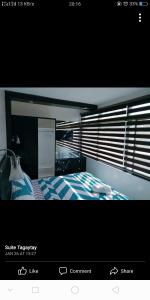 a picture of a bedroom with a bed and a window at Tagaytay Suite 2 in Tagaytay