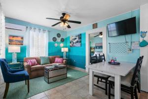 een woonkamer met een bank en een tafel bij Mermaids Grotto WATERFRONT 1BR Apt with Bay View in Tampa