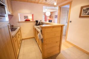 a kitchen with a sink and a counter at Chantemerle 6 in Méribel