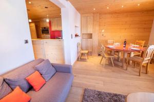 a living room with a couch and a table at Chantemerle 6 in Méribel