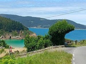 a road with a view of a body of water at Xilloi Beach Resort in O Vicedo