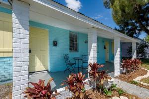 a blue house with a yellow door and a patio at The Sea House WATERFRONT Apt by Downtown in Tampa
