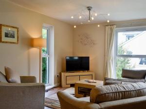 a living room with two couches and a television at Marina Apartment in Y Felinheli