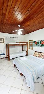 a bedroom with a bed and a wooden ceiling at Pousada Mandala in Búzios