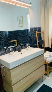 a bathroom with a sink and a mirror at Beautiful Private Room next to Lisbon - NEW in Paço de Arcos