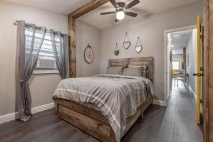 a bedroom with a bed and a ceiling fan at 2 Historic Ybor City Bungalows in the heart of Ybor City in Tampa