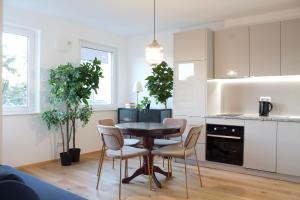 a kitchen and dining room with a table and chairs at STAD10 - Apartments very close to subway U2 Stadlau in Vienna