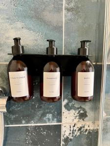 two bottles of soap on a shelf in a bathroom at The Stables Hideaway in Llanelli