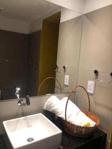 a bathroom with a sink and a mirror at Pousada Portas da Amazônia in São Luís