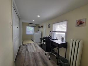 an office with a desk and a radiator in a room at The Iris - A Cheerful Midtown Getaway in Harrisburg