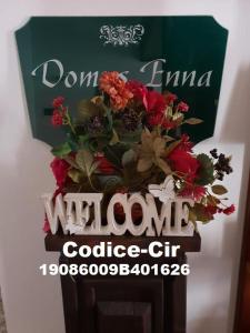 a sign for a wine company with a bouquet of flowers at B&B Domus Enna in Enna