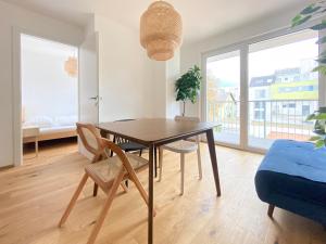 a dining room with a table and chairs and a window at STAD10 - Apartments very close to subway U2 Stadlau in Vienna