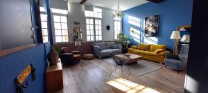 a large living room with blue walls and furniture at LA ROCHELAISE : Appartement calme & somptueux dans l'hyper centre. in La Rochelle