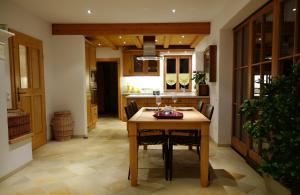 a kitchen with a wooden table and chairs at Apartment Sonnenfeld in Samerberg