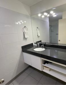 a bathroom with a sink and a mirror at Miraflores 2 Bedrooms Executive Apartment in Lima