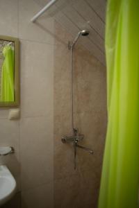 a shower with a glass door in a bathroom at Apex rest house in Yerevan