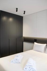 ein Schlafzimmer mit einem Bett mit Handtüchern darauf in der Unterkunft Seafront Apartment by C2C Architects in Kalívia Thorikoú
