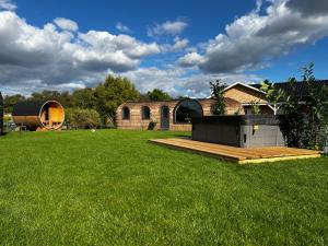 a backyard with a wooden deck and a house at Tirolian Lodge East in Bundorf