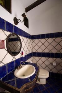 a bathroom with a sink and a toilet at Hotel Hacienda La Pacifica in Cañas