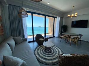 a living room with a couch and a table at Departamento catania con vista al mar in Mazatlán